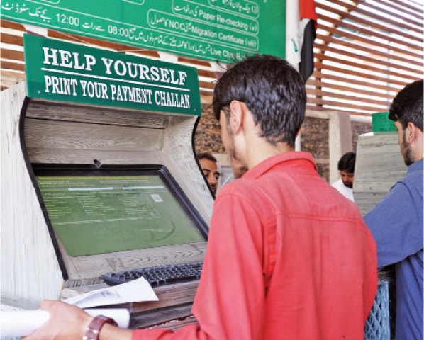 A student prints a payment slip at a kiosk. &mdash; Photos by Ishaque Chaudhry