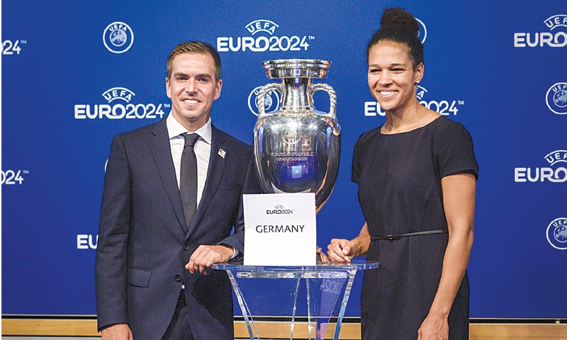 Head of Germany&rsquo;s bid to host the Euro 2024 Philipp Lahm (L) and former German international football player Celia Sasic pose with the UEFA trophy after the Germany was awarded hosting rights for the Euro 2024. &mdash;AFP