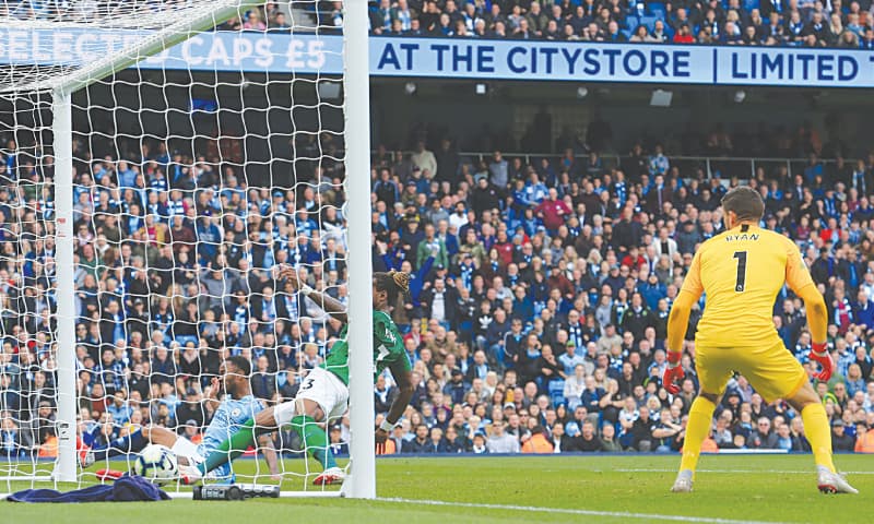 MANCHESTER: Manchester City’s Raheem Sterling (L) scores his team’s first goal past Brighton and Hove Albion’s goalkeeper Mathew Ryan during their English Premier League match at the Etihad Stadium on Saturday.—AFP MANCHESTER: Manchester City’s Raheem Sterling (L) scores his team’s first goal past Brighton and Hove Albion’s goalkeeper Mathew Ryan during their English Premier League match at the Etihad Stadium on Saturday.—AFP