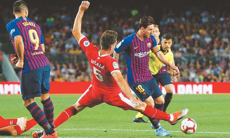 This file photo shows Girona's Bernardo Espinosa (C) tackle Barcelona's Lionel Messi during a previous La Liga match at the Nou Camp.