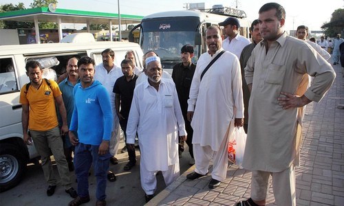 Pakistani workers, who were stranded in Saudi Arabia after losing their jobs, stand outside the old Islamabad airport after their return from Dammam in September 2016.—Online