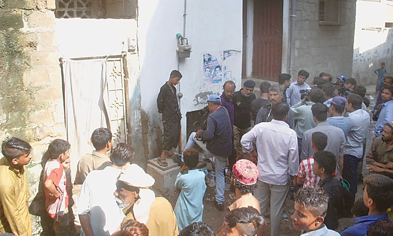 PEOPLE gather outside Ghaffar Zikri&rsquo;s house in Lyari&rsquo;s Ali Mohammed Mohalla on Thursday.&mdash;Online