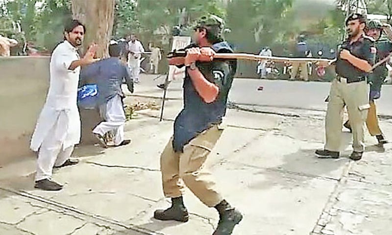 Police baton-charge a student during a protest against hike in tuition and hostel fees at the University of Peshawar on Thursday. — Dawn Police baton-charge a student during a protest against hike in tuition and hostel fees at the University of Peshawar on Thursday. — Dawn