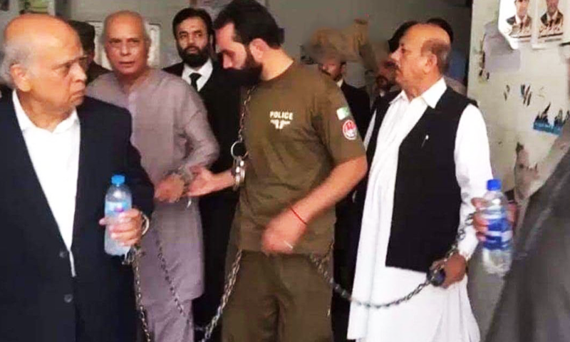 Ex-vice chancellor Dr Mujahid Kamran and four other former administrative officials of the Punjab University (PU) being taken away by NAB officials in handcuffs. —DawnNewsTV