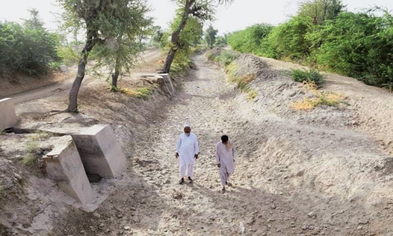 Villagers walk along a dried up canal near Badin. The disrupted water supply from the Indus has played havoc with this year’s planting of crops | Dawn File Photo