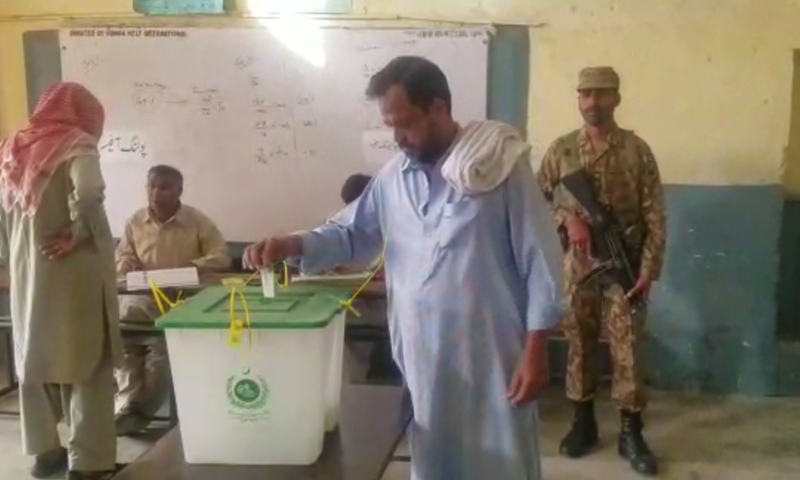 A man casts his vote in the by-polls. ─ DawnNewsTV