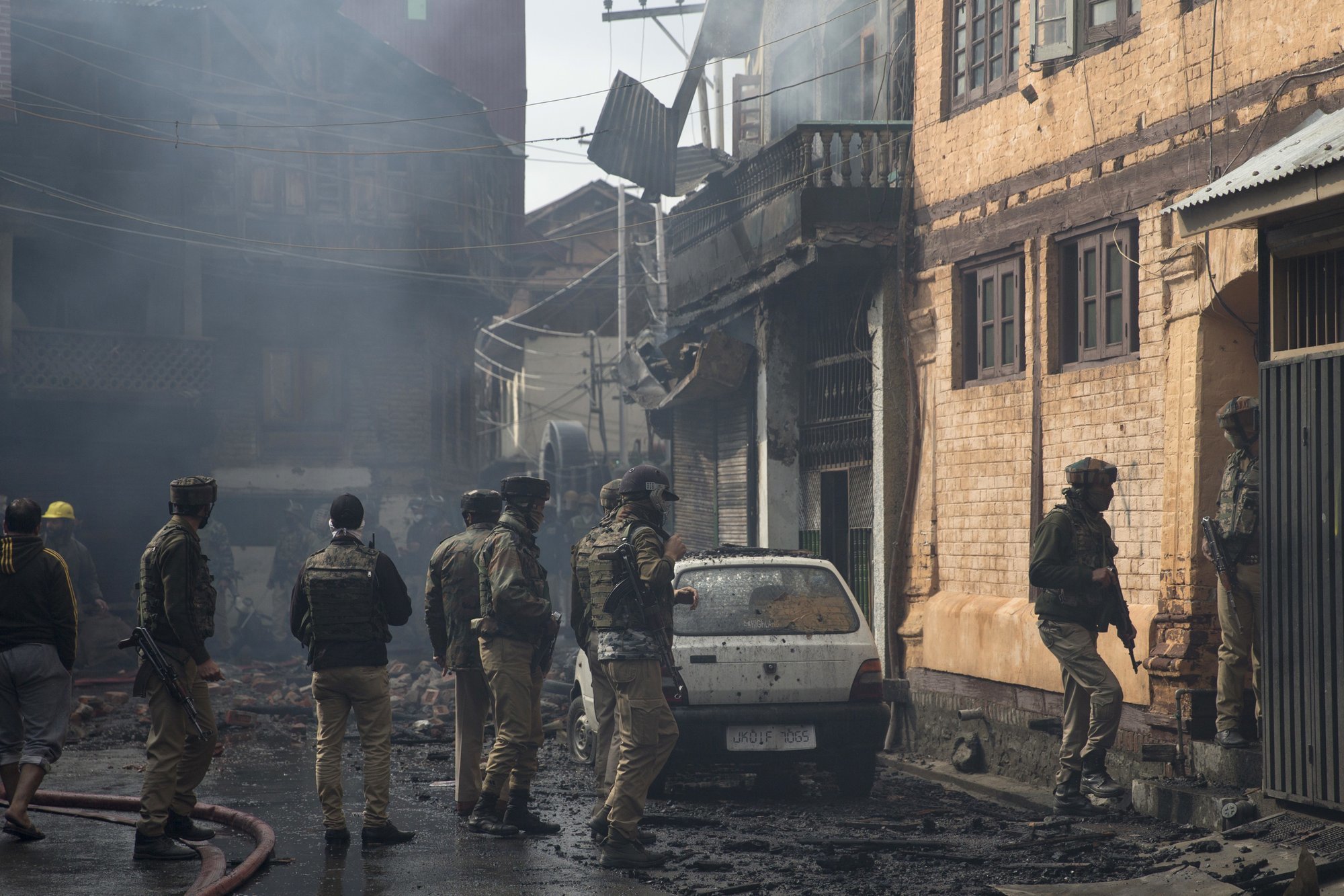 Indian policemen stands outside the house where a gunbattle took place on Wednesday. ─ AP