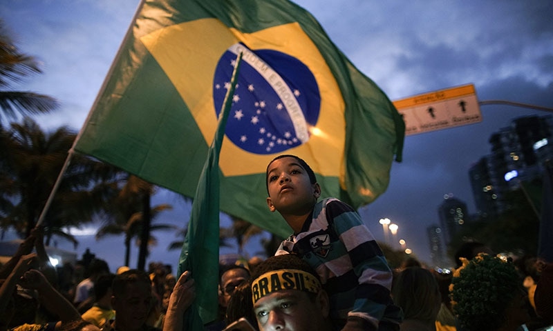 Supporters gather outside the residence of presidential candidate Jair Bolsonaro in anticipation of his victory speech, in Rio de Janeiro, Brazil on Sunday. &mdash; AP