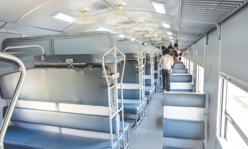 THE president, accompanied by the Railways minister, walks by the newly inaugurated train on Wednesday while (right) the interior of one of the carriages.—Fahim Siddiqi/White Star