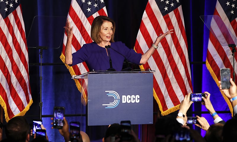 House Minority Leader Nancy Pelosi of California, smiles as she is cheered by a crowd of Democratic supporters during an election night returns event at the Hyatt Regency Hotel, on Nov 6, 2018, in Washington. ─ AP