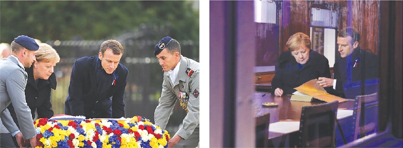Compiegne (France): German Chancellor Angela Merkel and French President Emmanuel Macron lay a wreath (left) in the Clearing of Rethondes or the Glade of the Armistice on Saturday. Macron and Merkel look at a guest book inside a replica of the wagon where the Armistice was signed in 1918.&mdash;Agencies