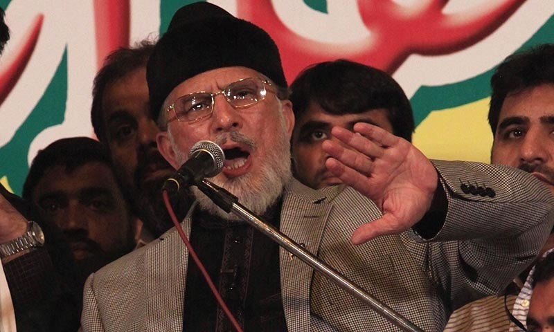 Tahir ul-Qadri, Sufi cleric and leader of political party Pakistan Awami Tehreek (PAT), speaks to his supporters in front of the Parliament House building during a "Revolution March" in Islamabad August 28, 2014. — File photo