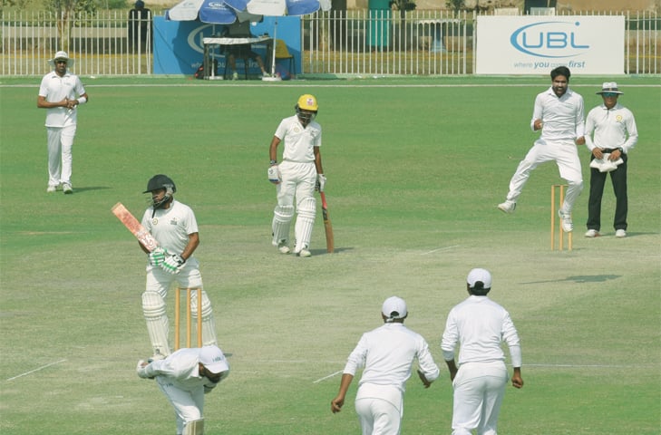 KARACHI: HBL&rsquo;s Amad Butt jumps in celebration after having Peshawar captain Akbar Badshah caught behind for 49 during the last-round Super Eight tie of the Quaid-i-Azam Trophy National Cricket Championship at the UBL Sports Complex.&mdash;Tahir Jamal / White Star