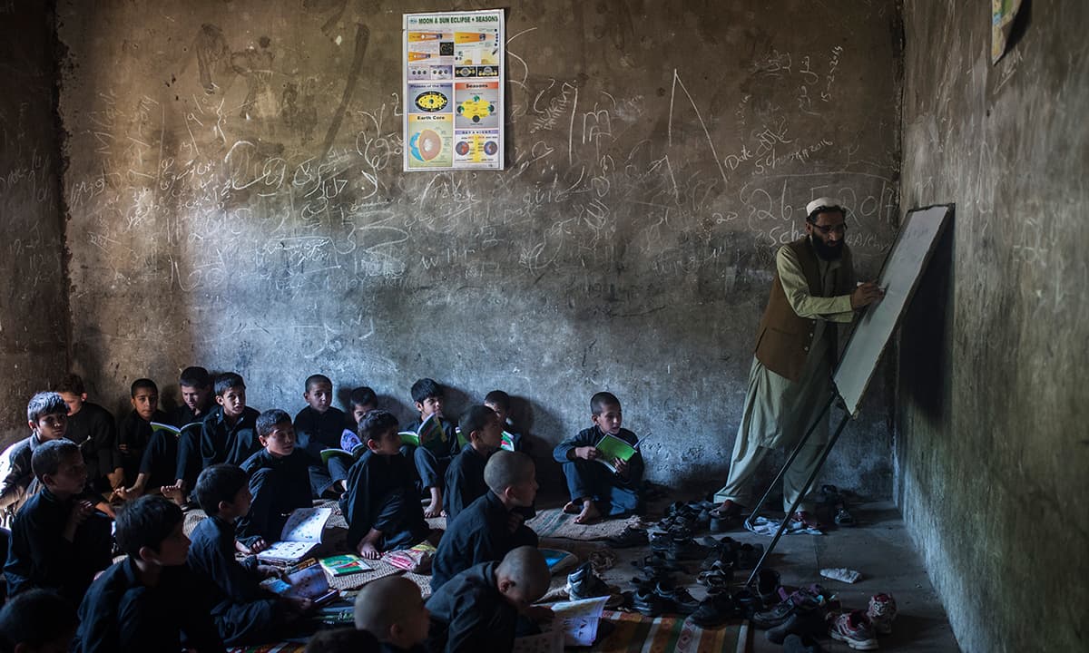 The main building of the Government Primary School Bankad, South Kohistan, lies three hours from the main road. It was damaged during the 2005 earthquake, leaving only one building usable. Students study in corridors outside the building and sit on the ground