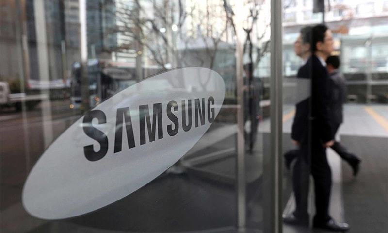 In this file photo, an employee walks past a logo of the Samsung Electronics Co. at its office in Seoul, South Korea. ─ AP/File