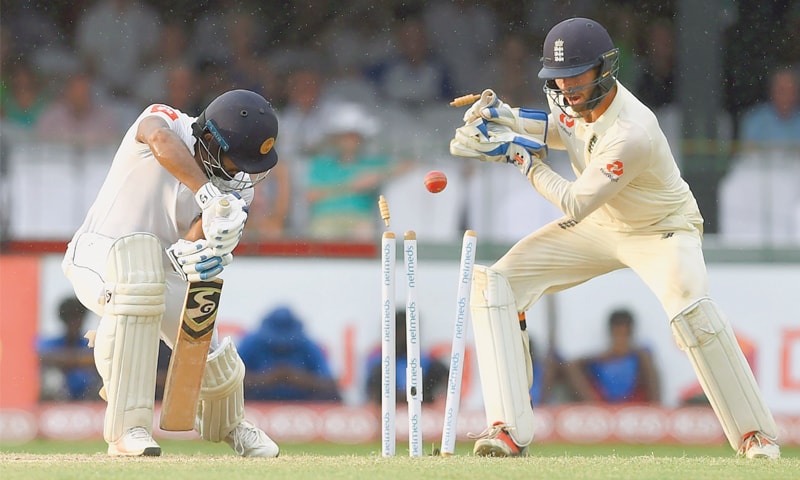 COLOMBO: England wicket-keeper Ben Foakes looks on as Sri Lankan opener Dimuth Karunaratne is cleaned up during the third day of the third Test at the SSC Ground.—AFP COLOMBO: England wicket-keeper Ben Foakes looks on as Sri Lankan opener Dimuth Karunaratne is cleaned up during the third day of the third Test at the SSC Ground.—AFP
