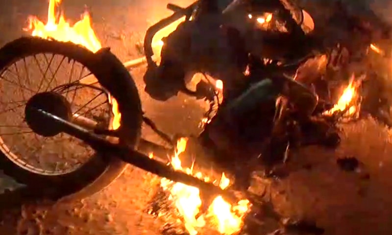 A motorcycle set on fire in Korangi. — DawnNewsTV