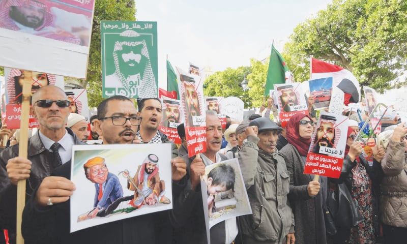 Tunis: Demonstrators shout slogans and hold up signs as they protest the visit of Saudi Crown Prince Mohammed bin Salman to Tunisia.&mdash;AFP