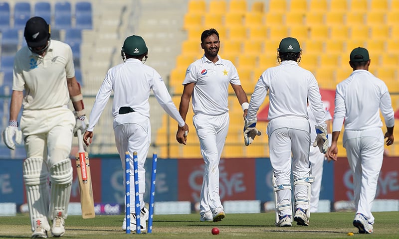 Bilal Asif (C) celebrates with teammates after taking the wicket of New Zealand batsman Will Somerville. — AFP