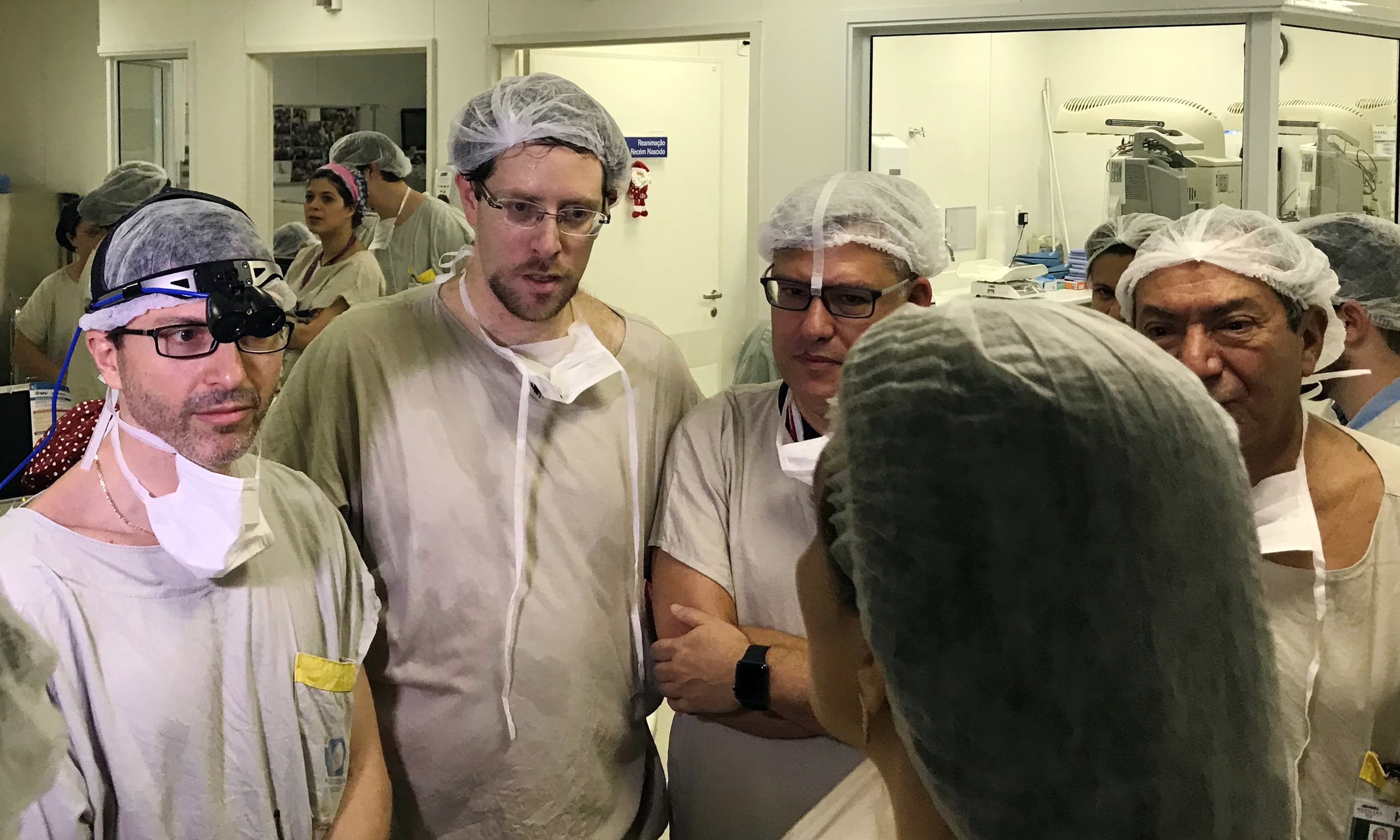 In this Dec 15, 2017, photo provided by transplant surgeon Dr. Wellington Andraus, left with magnifying glasses, he and Dr Dani Ejzenberg, second left, confer with colleagues at the hospital. &mdash;AP