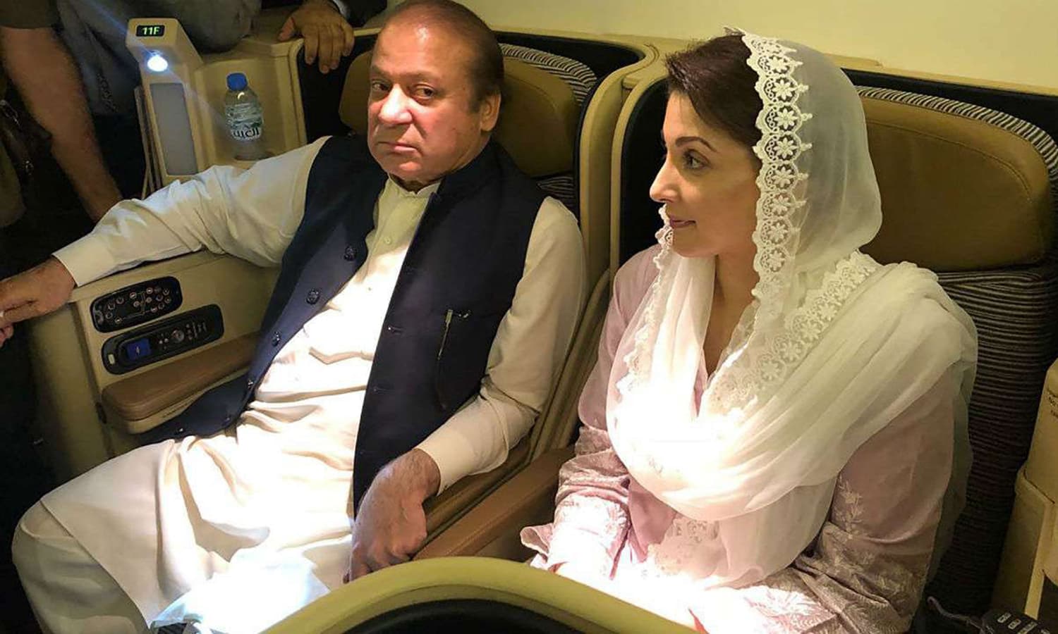 Nawaz Sharif and daughter Maryam on a Lahore-bound flight on July 13, 2018 to surrender to NAB. — AFP