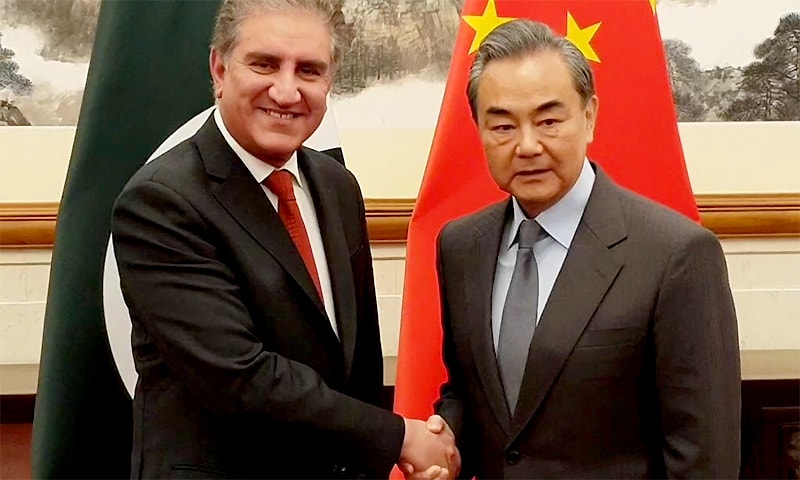 Foreign Minister Shah Mahmood Qureshi and his Chinese counterpart, Wang Yi, shake hands in Beijing. ─ Photo courtesy Dr Muhammad Faisal Twitter