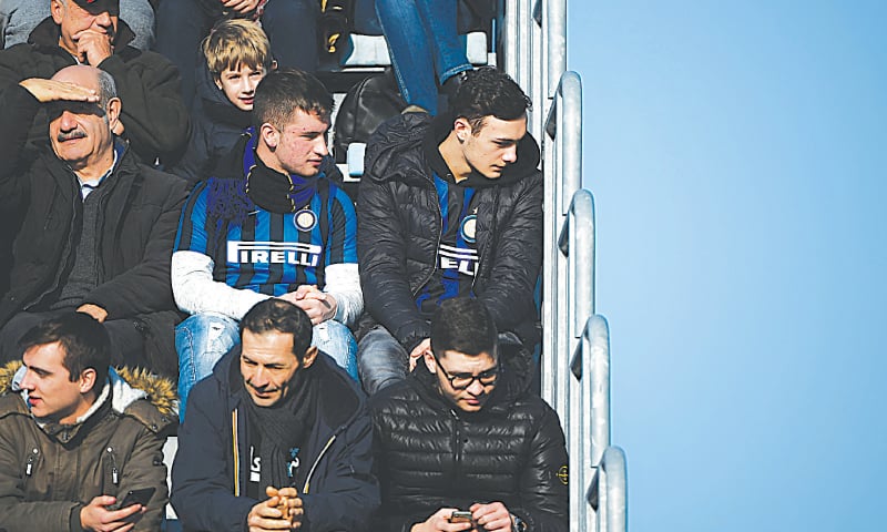 EMPOLI: Inter Milan fans, wearing their side&rsquo;s jerseys, wait in the tribunes prior to the Serie A match against Empoli at the Carlo-Castellani Stadium. Empoli had suspended the sales of tickets reserved for Inter fans after violence and chanting overshadowed the team&rsquo;s Boxing Day match against Napoli at the San Siro.&mdash;AFP