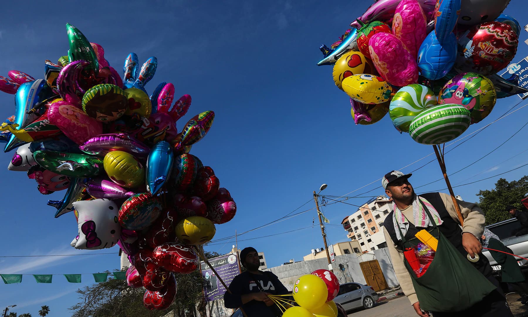 A Palestinian man sells balloons ahead of New Year's celebrations in Gaza City on December 31. — AFP