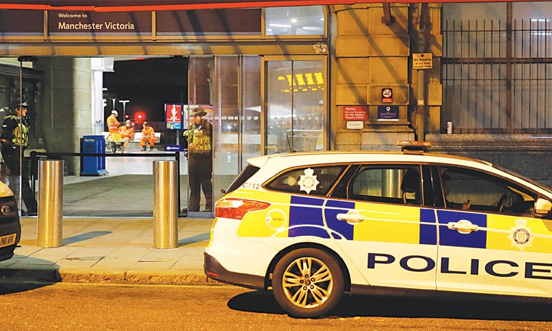 Manchester: Police officers stand at the end of a tram platform following a stabbing at Victoria Station on Tuesday.&mdash;Reuters