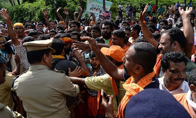 Indian policemen contain Hindu devotees and activist during a protest against the Supreme Court verdict revoking a ban on women's entry to Sabarimala's Ayyappa Hindu temple, in Nilackal in the southern Kerala state on October 17. &mdash; File