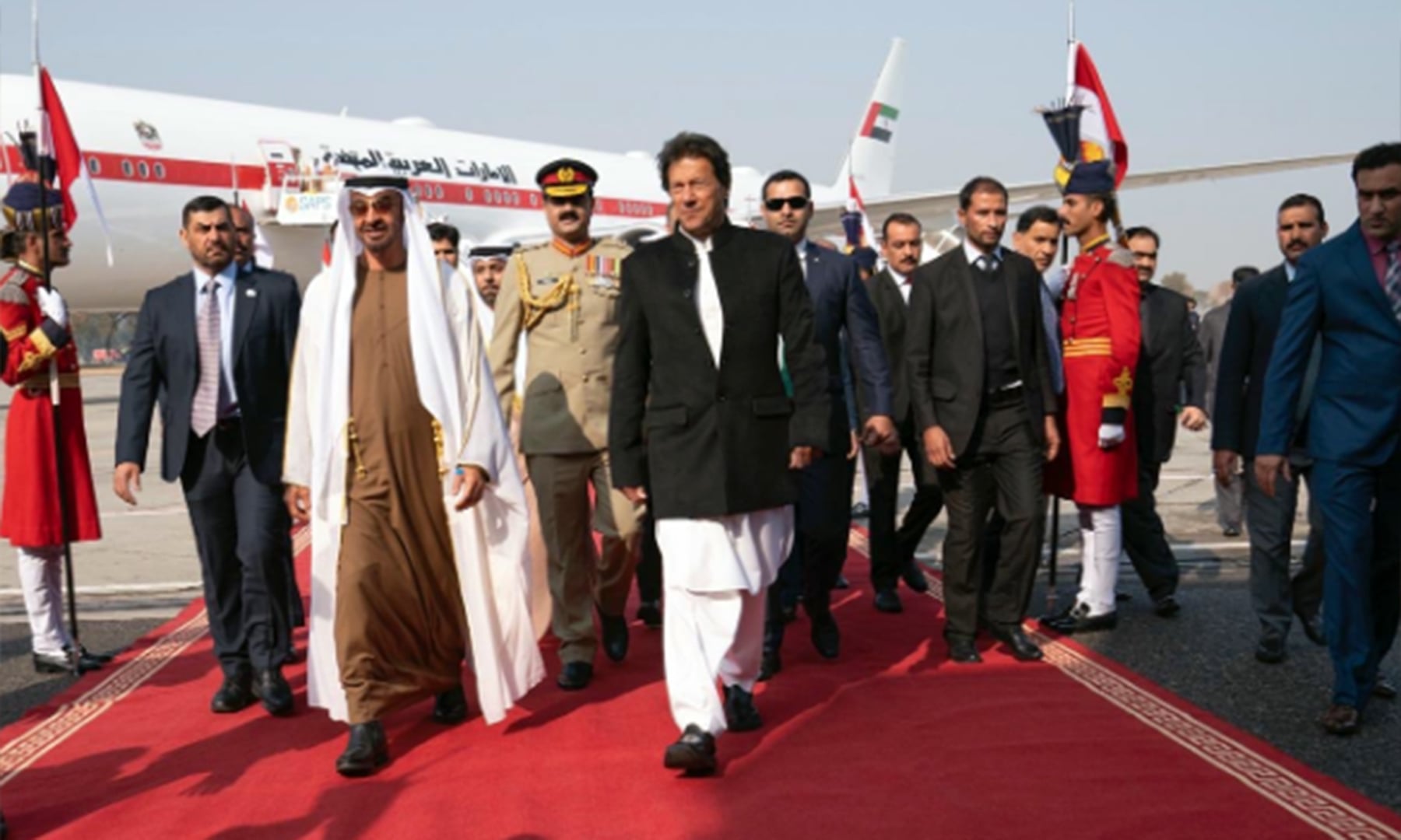 Prime Minister Khan walks with the UAE royal at Nur Khan airbase. — Photo courtesy UAE Embassy PK Twitter