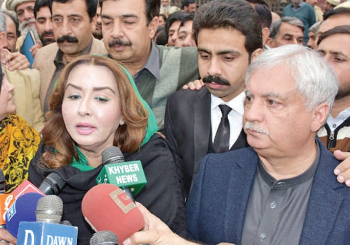 Dr Arbab Alamgir and Asma Alamgir talk to mediapersons after appearing in the accountability court in Peshawar on Thursday. — White Star