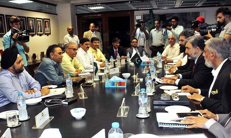 Pakistan’s Commissioner for Indus Waters Syed Muhammad Mehar Ali Shah and members of his team talk to Indian Indus Water Commissioner Pradeep Kumar Saxena and other members of his delegation during a meeting in Lahore in August. — APP/File