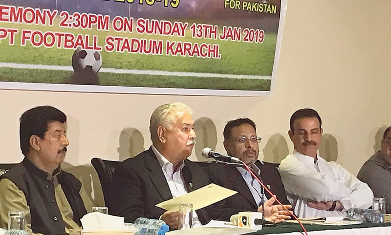KARACHI: PFF president Ashfaq Hussain Shah (second L) gestures during a news conference on Saturday.&mdash;UW