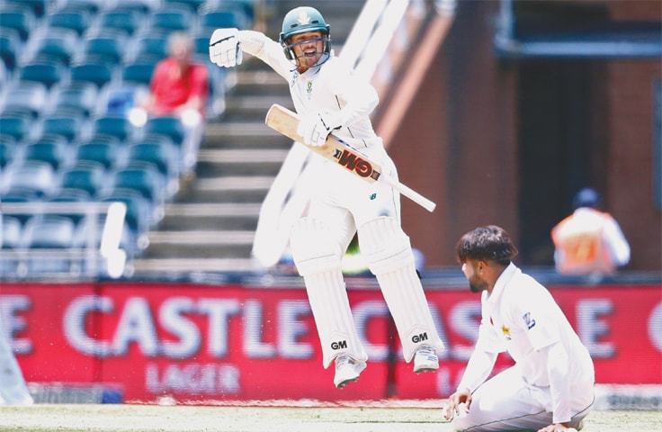 JOHANNESBURG: Pakistan paceman Faheem Ashraf (R) watches South African batsman Quinton de Kock punches the air in delight after reaching  his century in the third and final  Test at the Wanderers on Sunday.—AFP