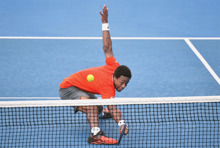 MELBOURNE: France’s Gael Monfils returns to Taylor Fritz of the US during their match at the Australian Open on Wednesday.—AFP