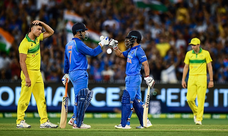 Dhoni (2nd L) and Kedar Jadhav (2nd R) celebrate after defeating Australia during the third ODI match. — AFP