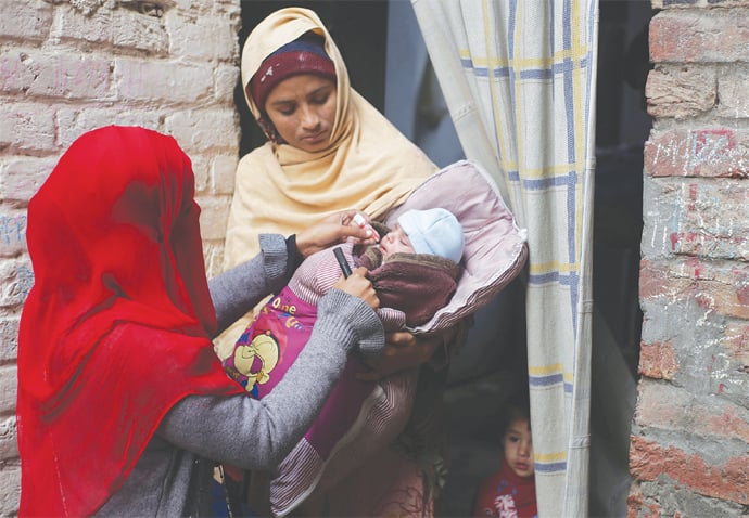 Lahore: A health worker administers polio drops to a child on Monday.—AP