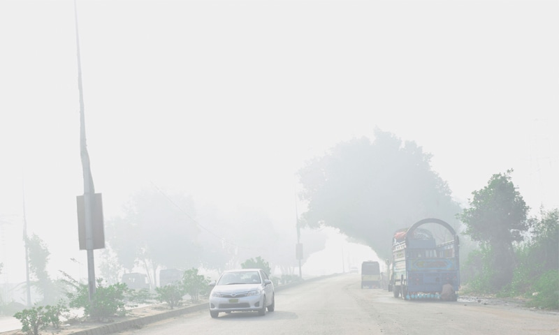 A FEW vehicles ply on a road in Hyderabad due to fog on Tuesday morning.—Dawn A FEW vehicles ply on a road in Hyderabad due to fog on Tuesday morning.—Dawn
