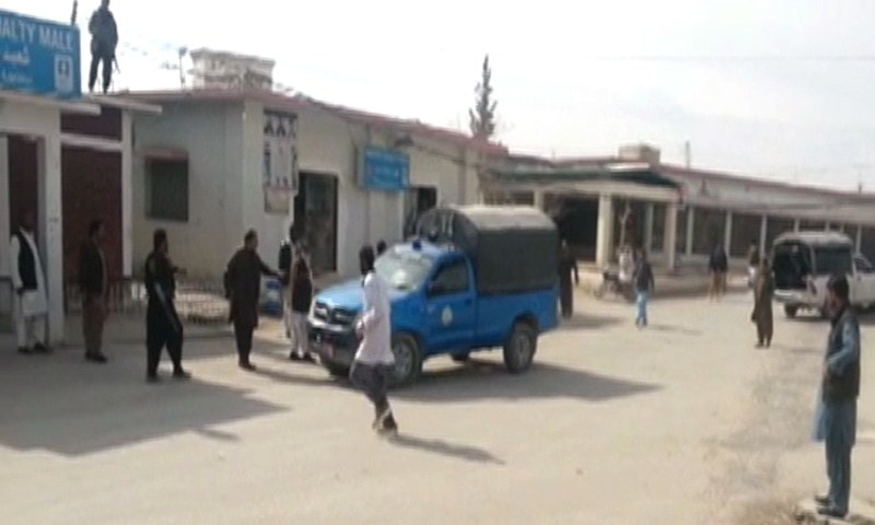 Security officials are seen outside a hospital where the bodies and injured were brought. — DawnNewsTV