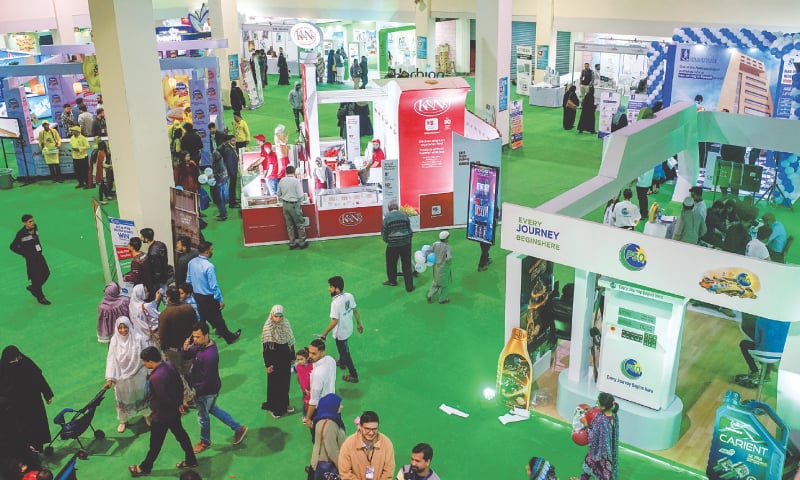 PEOPLE visit various stalls at one of the halls in the exhibition on Friday.&mdash;White Star