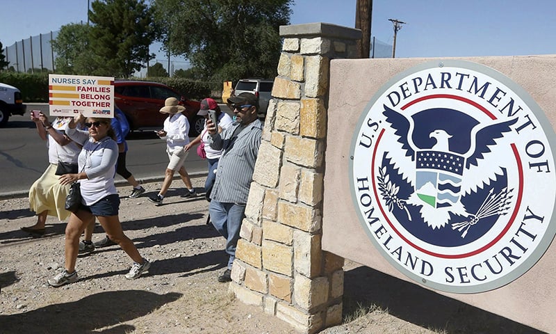 This June 2018 file photo shows protesters walking along Montana Avenue outside the El Paso Processing Center, in El Paso, Texas. &mdash; AP