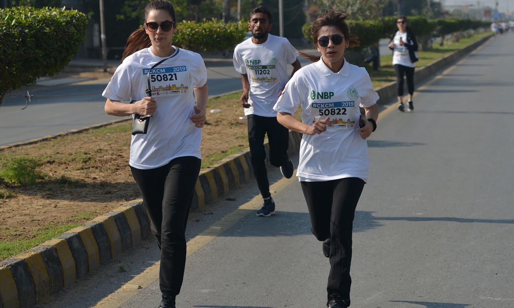 Runners compete in the 10-kilometre Commissioner Karachi Marathon. — AFP