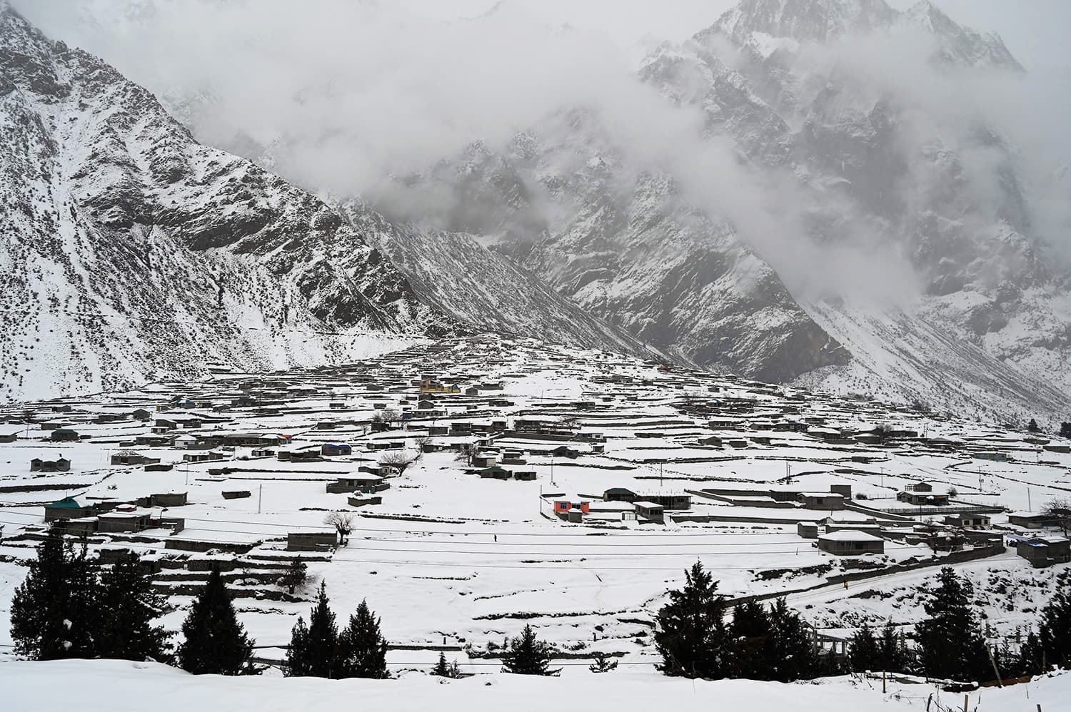 A general view of the snow-covered homes in the Naltar Valley. ─ AFP