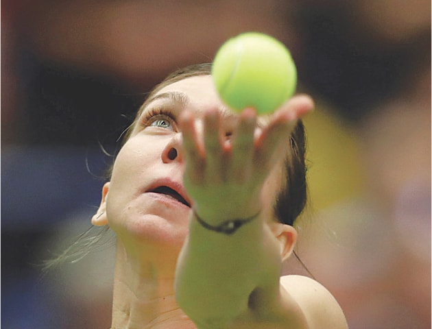 OSTRAVA: Romania’s Simona Halep serves to Karolina Pliskova of the Czech Republic during their Fed Cup match at the Ostravar Arena.—Reuters