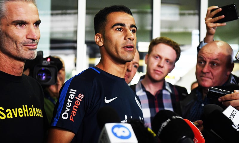 Footballer Hakeem al-Araibi speaks to the media beside ex-Socceroos captain Craig Foster upon his arrival at the airport in Melbourne.— AFP