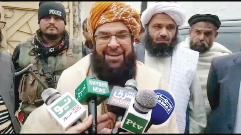 JUI-F central general secretary Maulana Abdul Ghafoor Haideri talking to journalists in Swabi on Thursday. — Dawn