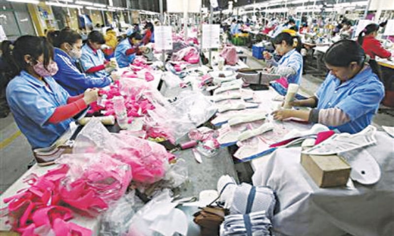 Employees work on an assembly line at a shoe factory in Tan Lap village, outside Hanoi. In 2013 Vietnam approved a broad plan to boost its economy, focusing on restructuring public investment, banks and state-owned enterprises while controlling inflation and maintaining growth.—Reuters