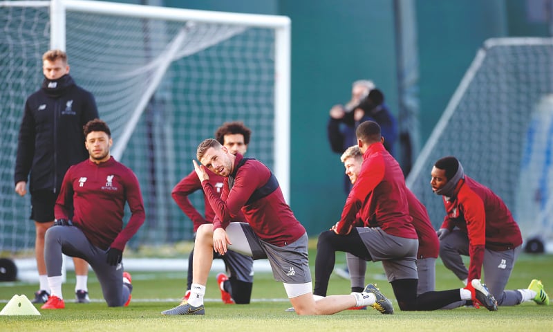 LIVERPOOL: Liverpool players stretch during a training session on Monday.—Reuters