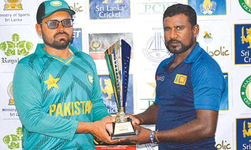 Pakistan skipper Nisar Ali and his Sri Lankan counterpart Priyantha Kumara pose with the series trophy.